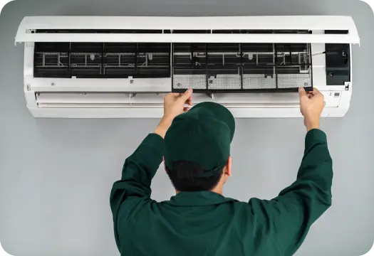 an electrician is fixing the air-conditioner
