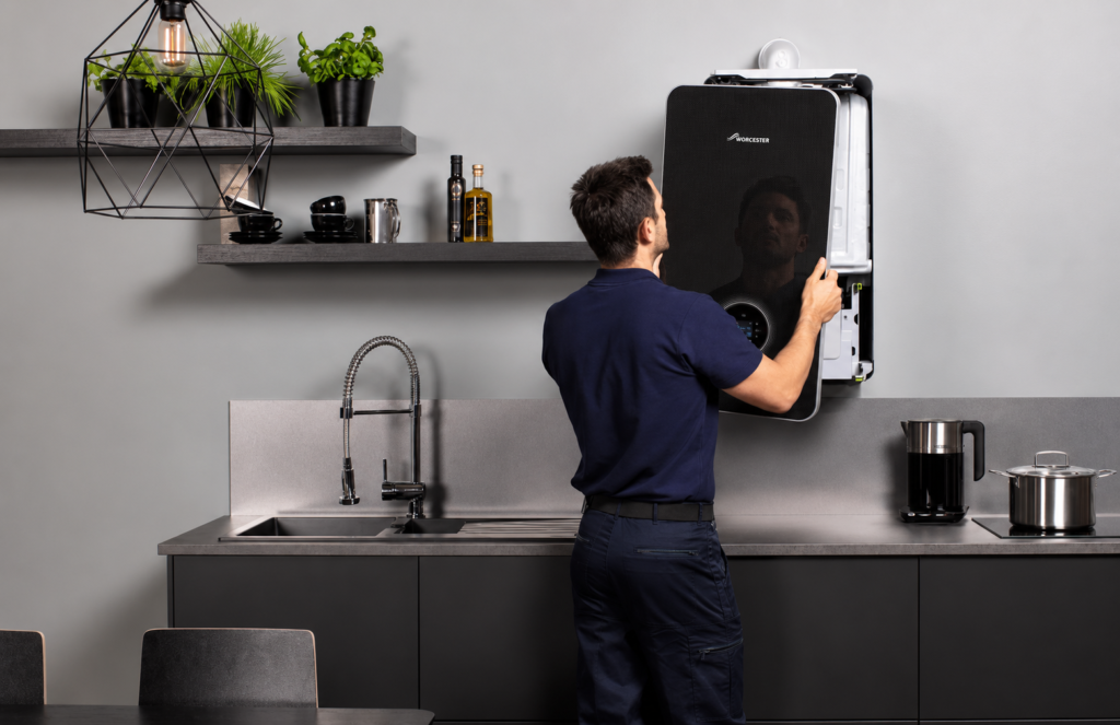 Engineer Fitting Boiler On Wall